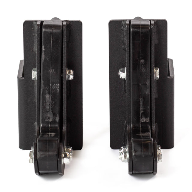 Two black Sandwich J-Cups by Bells of Steel, made of plastic and metal, stand upright side by side. Each features a vertical hinge with bolts at the base, all displayed on a white background.