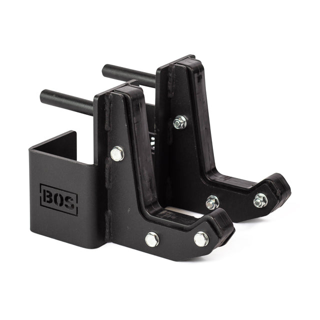 Two black metal Sandwich J-Cups by Bells of Steel, with bolts, rubber padding, and the "BOS" logo. These heavy-duty rack attachments securely hold objects. The pair is shown side by side against a white background.