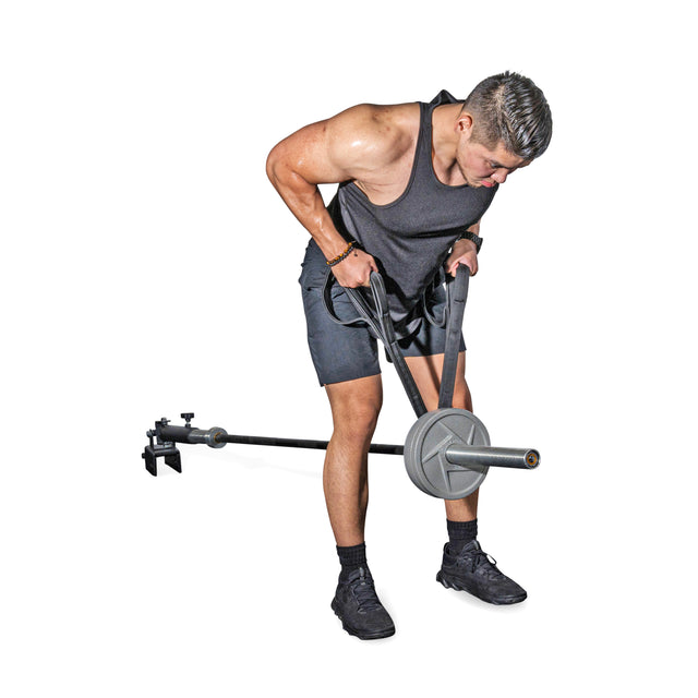 A man in athletic wear uses the Bells of Steel RocIT Tricep Strap with a landmine barbell and t-bar row attachment, performing a bent-over row against a white background.