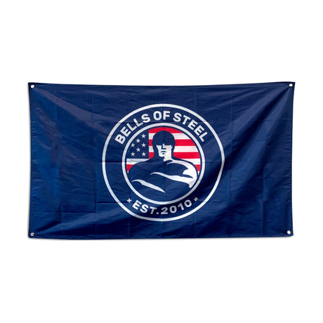 The Bells of Steel Flags feature their "EST. 2010" logo with a muscular figure and American flag motif in navy blue—ideal gym decor for any fitness space.