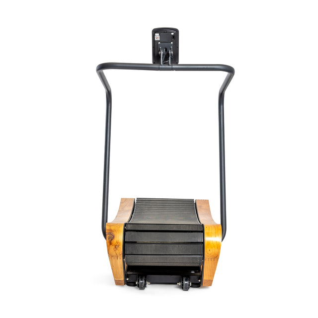 The Bells of Steel Wooden Residential Manual Treadmill features a black frame and digital display, blending natural wood and metal. This self-powered treadmill's compact, minimalist design is uniquely angled towards the front.
