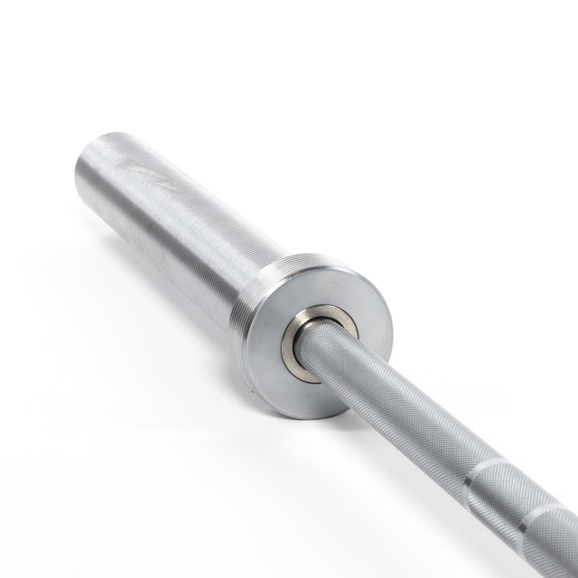 A close-up of the Bells of Steel Oly Lifting Needle Bearing Bar - Women's, featuring a silver 25mm shaft, textured grip, and rotating sleeve, photographed on a white background.