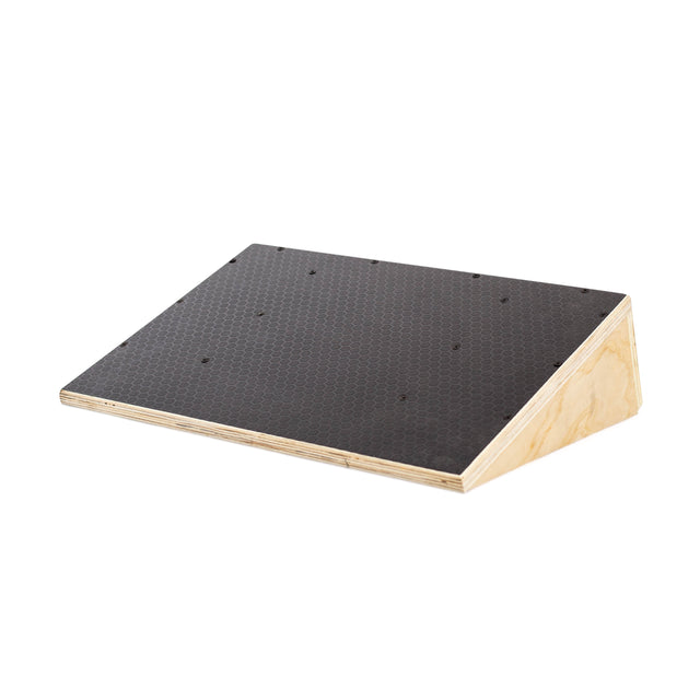 The Bells of Steel Squat Wedge Board features a black textured surface and exposed plywood edges, designed to enhance squat depth or ankle mobility, shown on a white background.