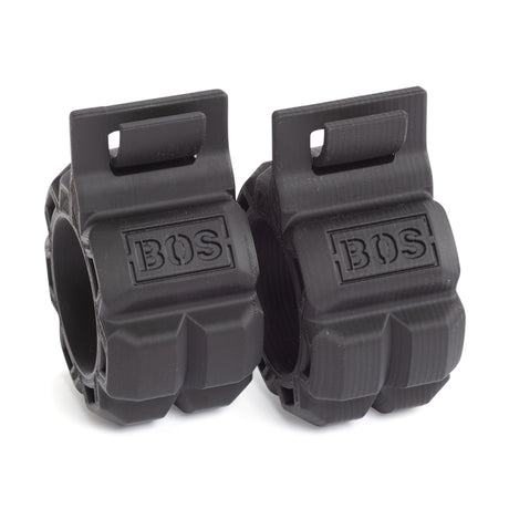 Bells of Steel Barbell Zip Clips are black, heavy-duty plastic clips with "BOS" on the front. Their rugged design and top locking mechanism securely hold plates, ensuring stability during your workouts. Set includes two clips.