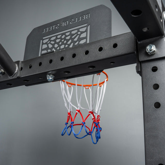 The Bells of Steel Rack Attached Basketball Hoop w/ Ball features a branded backboard and a red, white, and blue net on a black metal frame—perfect for adding fun to your home gym.