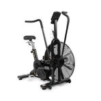 The Bells of Steel Blitz Air Bike is a commercial-grade indoor cardio machine with a large front fan, adjustable seat, moving handlebars, sturdy build, digital display above the fan, and a smooth belt drive system.