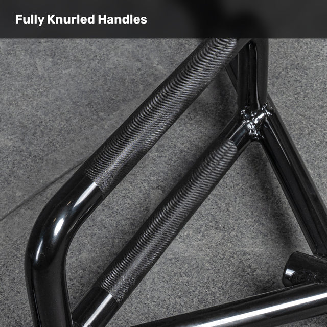 Close-up of a black metal handle with full knurled grip on a gray textured surface. Text reads, "Fully Knurled Handles"—ideal for strength training or adding to your Bells of Steel Open Trap Bar / Hex Bar setup.
