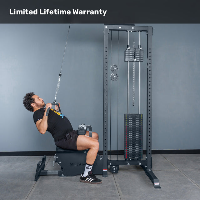 A man uses the Bells of Steel Lat Pulldown Low Row Machine for cable back training in a gym with a gray background. "Limited Lifetime Warranty" is displayed at the top.