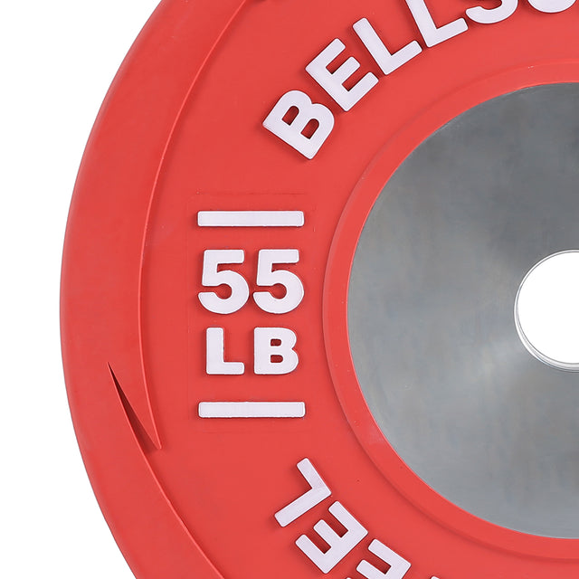 Close-up of a red Boltless LB Competition Bumper Plate by Bells of Steel, featuring "55 LB" in white and a shiny center hole. Made to IWF specs for Olympic lifts. Partially visible brand name.