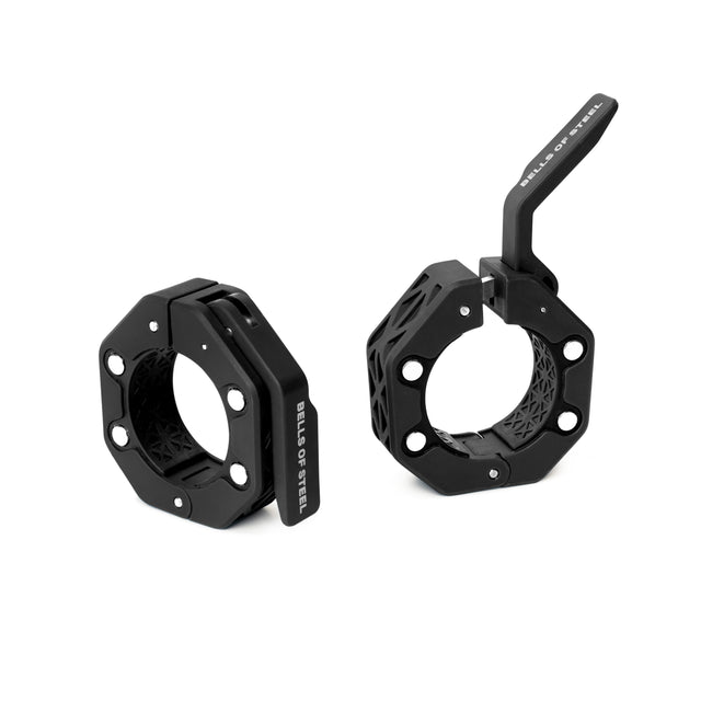 Two black, octagonal Magnetic Clamp Collars by Bells of Steelโone closed and upright, one open to reveal the lever mechanism. Both feature a modern, geometric design for secure lifts.