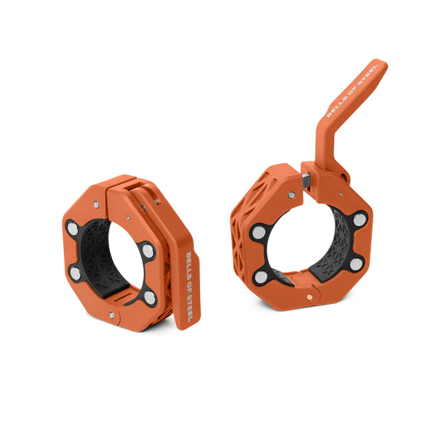 Two orange Magnetic Clamp Collars by Bells of Steel, one open and one closed with a raised lever, feature black inner grips and silver screws for securely fastening weight plates to a barbell.