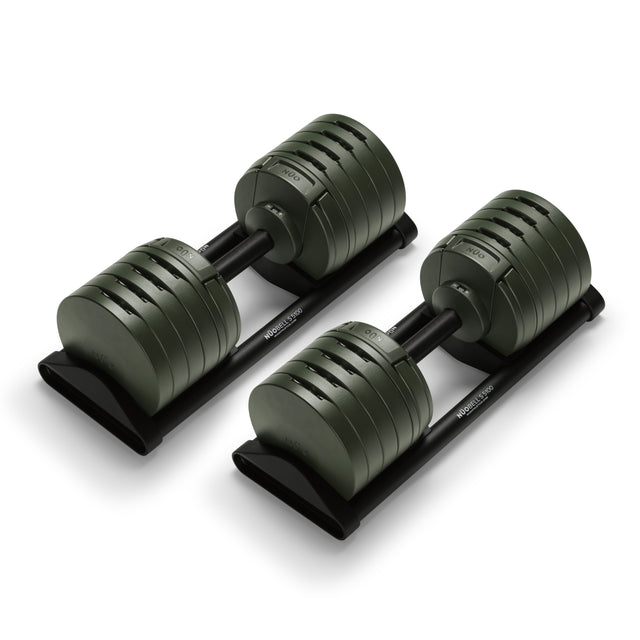 The Bells of Steel USA NÜOBELL-S Adjustable Dumbbells, with dark green weight plates and sleek black holders, bring style and versatility to your home gym.