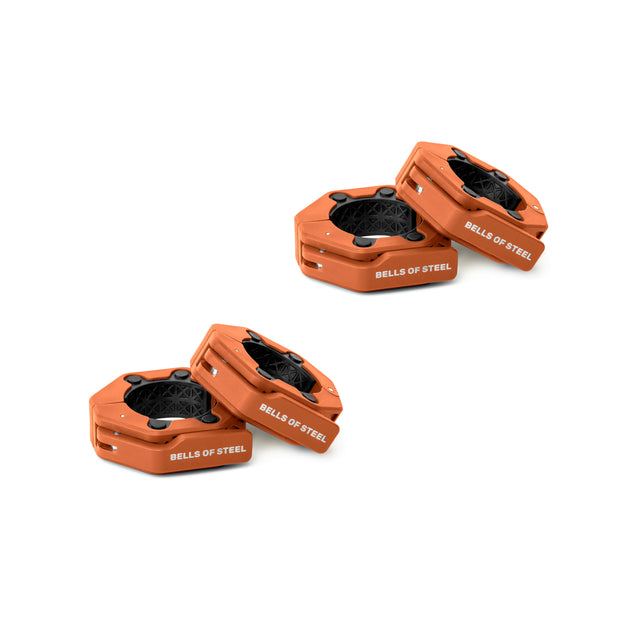 Four orange Bells of Steel Magnetic Clamp Collars with black locking mechanisms are arranged in pairs on a white background, highlighting their secure hold for weight plates.