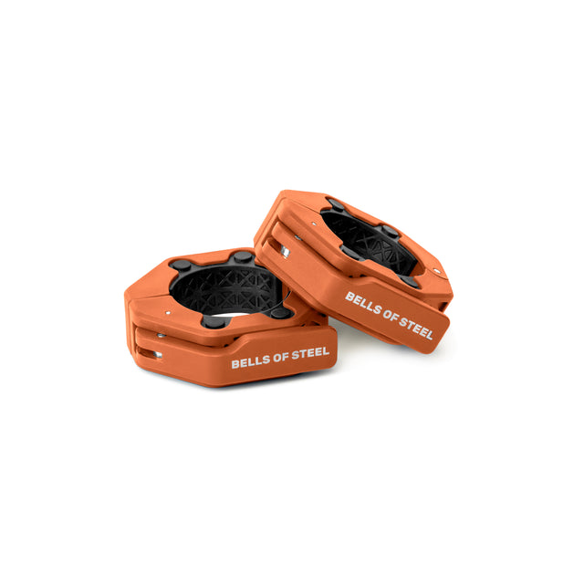 Magnetic Clamp Collars by Bells of Steel feature orange hexagonal design, black center grips, and white branding. These barbell collars provide a secure, magnetic fit and are shown on a white background.