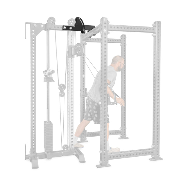 A man performs a cable chest fly using the Bells of Steel USA 3x3 Cable Tower to Rack Connection Kit, highlighted against a faded, space-efficient power rack setup.