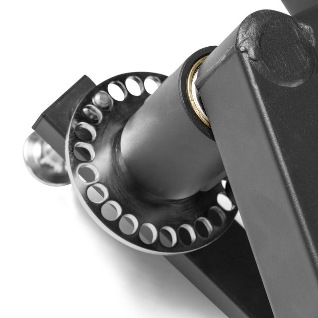 Close-up of the Bells of Steel Shoulder Boulder/Chest Fly Attachment, featuring a metal hinge and round perforated plate connected to a black frame, designed for adjustable gym equipment.