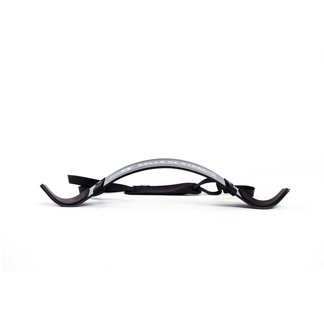 The Bells of Steel Arm Blaster is a black and silver curved plastic arm support with two hook-like ends and an adjustable strap, perfect for tricep pushdowns or bicep curls, shown on a white background.