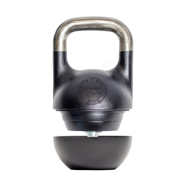 The Bells of Steel Mark Wildman Adjustable Kettlebell in black and silver features a detachable bottom half, shown separated on a white background, inspired by Mark Wildman’s competition kettlebell training tools.