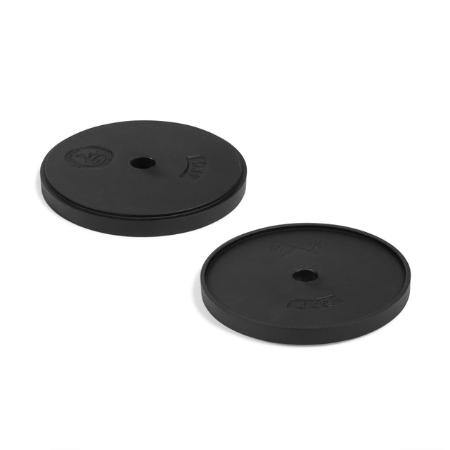 Two black round weight plates with center holes from the 48KG Extension Kit for Adjustable Kettlebell—Wildman Poison Pill by Bells of Steel USA are shown on a white background, ideal for upgrading your adjustable kettlebell or expanding your kettlebell set.