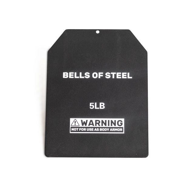 The Bells of Steel USA Weighted Vest includes a black 5LB weight plate made from durable steel, engraved with "BELLS OF STEEL 5LB" and a warning: "NOT FOR USE AS BODY ARMOR." It has a slanted top edge and small central hole for easy attachment to the vest.