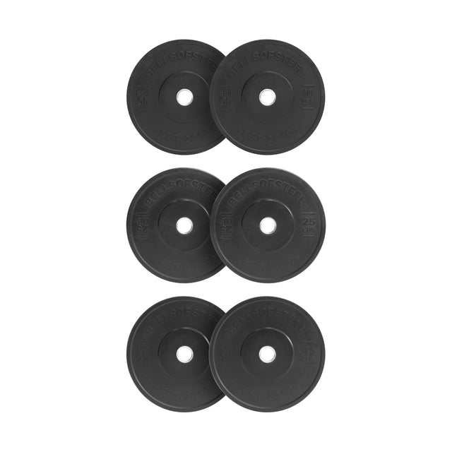 Six All-Black Bumper Plates by Bells of Steel are stacked in two columns with three plates each. They have writing and a central barbell fitting hole, and the background is plain white.