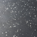 Close-up of the Bells of Steel Rubber Flooring Gym Mat 24" x 24" in dark gray with white stone chips, featuring a speckled, textured surface ideal for durable, heavy-duty gym spaces.