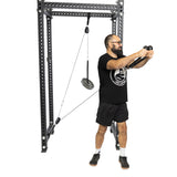 A man in athletic wear uses the Bells of Steel Tricep Rope Extension, gripping the cable machine attachment and performing an exercise with visible frame and cables.