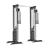 The Bells of Steel Cable Tower Squat Stands are perfect for a home gym, featuring a robust metal framework with dual adjustable pulleys, two weight stacks, and a central pull-up bar at the top, making it ideal for strength training exercises.