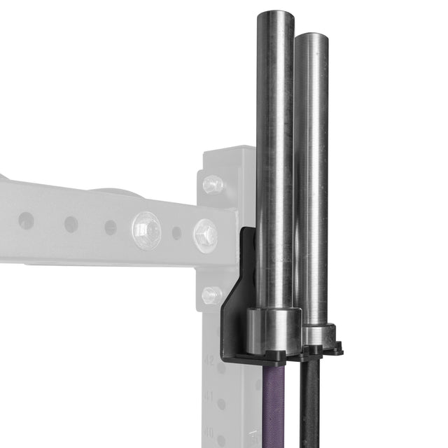 The Bells of Steel Hanging Barbell Holders, in black metal, are attached to a gray gym rack for secure vertical storage of two silver barbells. A black rubber band is visible below the holders.