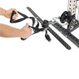 Close-up of a person's hands holding the Bells of Steel 30 D-Handle Bar Cable Attachment with Carabiners, featuring black nylon handles and metal hardware, attached to an exercise machine, isolated on a white background.