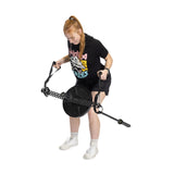 A person with red hair in a ponytail uses the Bells of Steel 30 D-Handle Bar Cable Attachment with Carabiners, wearing a black T-shirt, black shorts, and white sneakers, standing on a white background.