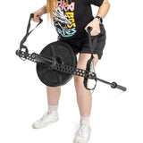 A person in shorts and a graphic t-shirt uses the Bells of Steel 30 D-Handle Bar Cable Attachment with Carabiners for strength training, gripping the handles while standing on a white background.