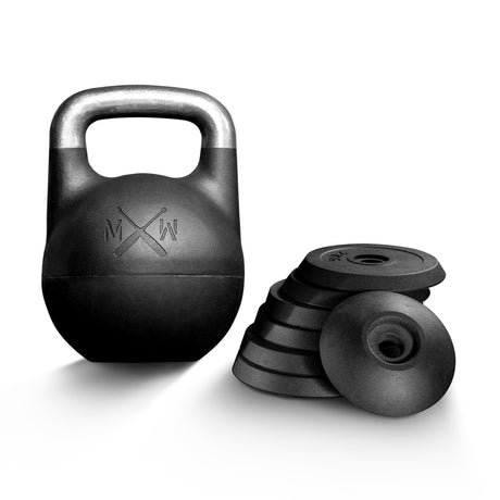 The Bells of Steel Mark Wildman Adjustable Kettlebell, a black competition-style kettlebell with a metallic handle, stands next to a stack of round, removable weight plates on a white background.