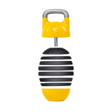 The Bells of Steel Adjustable Competition Kettlebell is a yellow and black handheld percussion instrument with a striped design, featuring a metal handle on top. It resembles an egg maraca and includes a circular grip for easy handling.