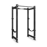 The Bells of Steel Manticore Four Post Power Rack Builder (3" x 3", 1" Holes) is a black steel squat rack featuring multiple adjustment holes, an integrated pull-up bar on top, and safety straps inside—perfectly designed for weightlifting and strength training in your home gym.