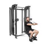 A man in a black shirt and shorts is using the Kraken Rack Attachment for 4 Post Hydra & Manticore Racks by Bells of Steel for seated rows. He sits securely on a bench, benefiting from its adjustable trolleys and sturdy metal frame for a smooth workout experience.