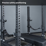 A close-up of the Bells of Steel USA Manticore Four Post Converter Bench, featuring adjustable safety straps and numbered holes. Text at the top reads, “Precise safety positioning.”.