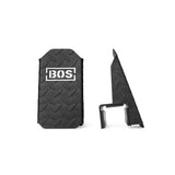 Two black, textured rectangular Footplates for Cable Tower/All In One Trainer by Bells of Steel USA, featuring a diamond plate pattern and "BOS" in white; one shows the front and the other the side with a clip-like attachment—ideal gym accessory.