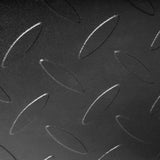 Close-up of a black metal Bells of Steel USA Footplate for Cable Tower/All In One Trainer, featuring a raised diamond plate pattern with repeating oval-shaped textured bumps.