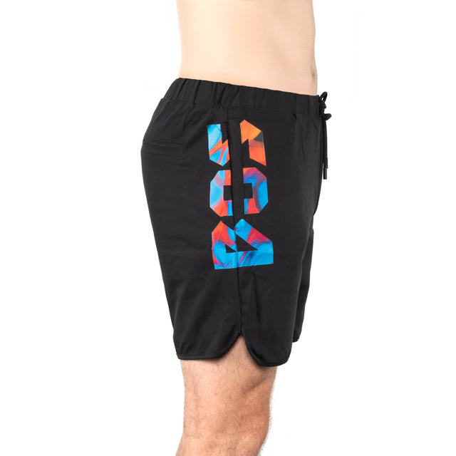 Side view of a person wearing Bells of Steel Gym Shorts in black with a colorful geometric design and number "89" on the side. Made from high-performance polyester, featuring an elastic waistband, stretchy fabric, and small pocket. The background is plain white.