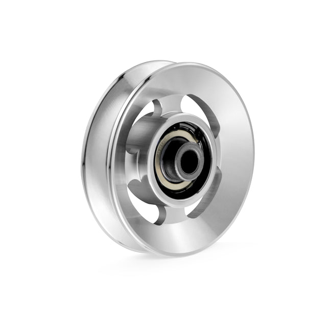 The Aluminum Pulley Wheels & Upgrade Kits by Bells of Steel are showcased in close-up, highlighting their shiny surface and intricate design. The central bearing and cut-out disc sections are set against a plain white background to emphasize the smooth and reflective aluminum craftsmanship.