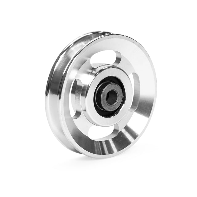 A shiny aluminum pulley wheel from Bells of Steel, featuring three large circular spokes and a central black hub. Its polished silver metallic finish beautifully reflects light, showcasing its sleek design. Ideal for cable machine applications, this is part of the Aluminum Pulley Wheels & Upgrade Kits.