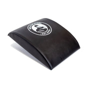 A portable black Sit Up Mat by Bells of Steel, featuring their "Est. 2010" logo and bicep curl design, provides optimal lumbar support for workouts.