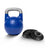 The Bells of Steel Adjustable Competition Kettlebell rests beside black weight plates, forming a versatile kettlebell set on a white background.