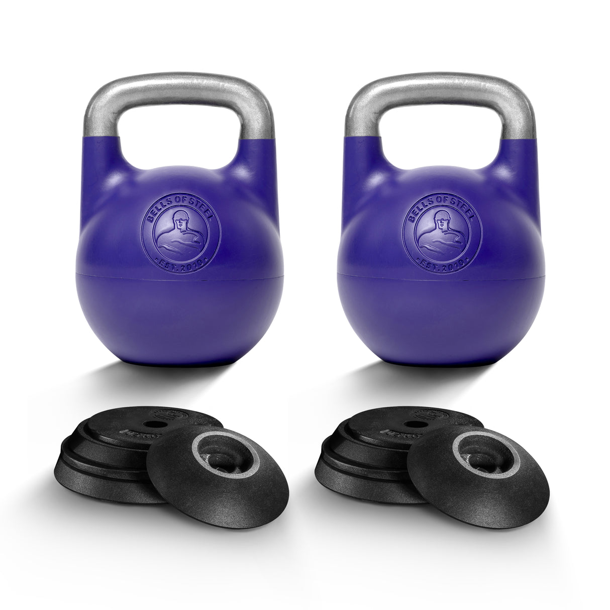 Two Bells of Steel Adjustable Competition Kettlebells with silver handles are displayed behind two sets of three black weight plates each, all arranged on a white background.