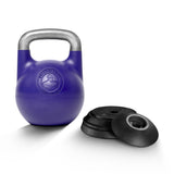 A Bells of Steel Adjustable Competition Kettlebell with a silver handle is positioned beside four stacked black weight plates on a white background.