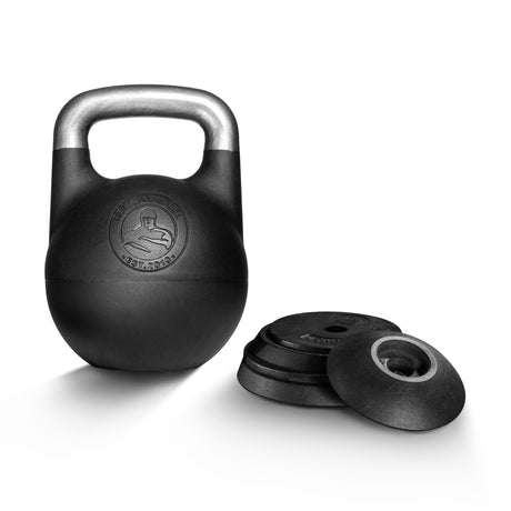 The Bells of Steel Adjustable Competition Kettlebell with a silver handle stands upright beside a stack of black weight plates on a white background.
