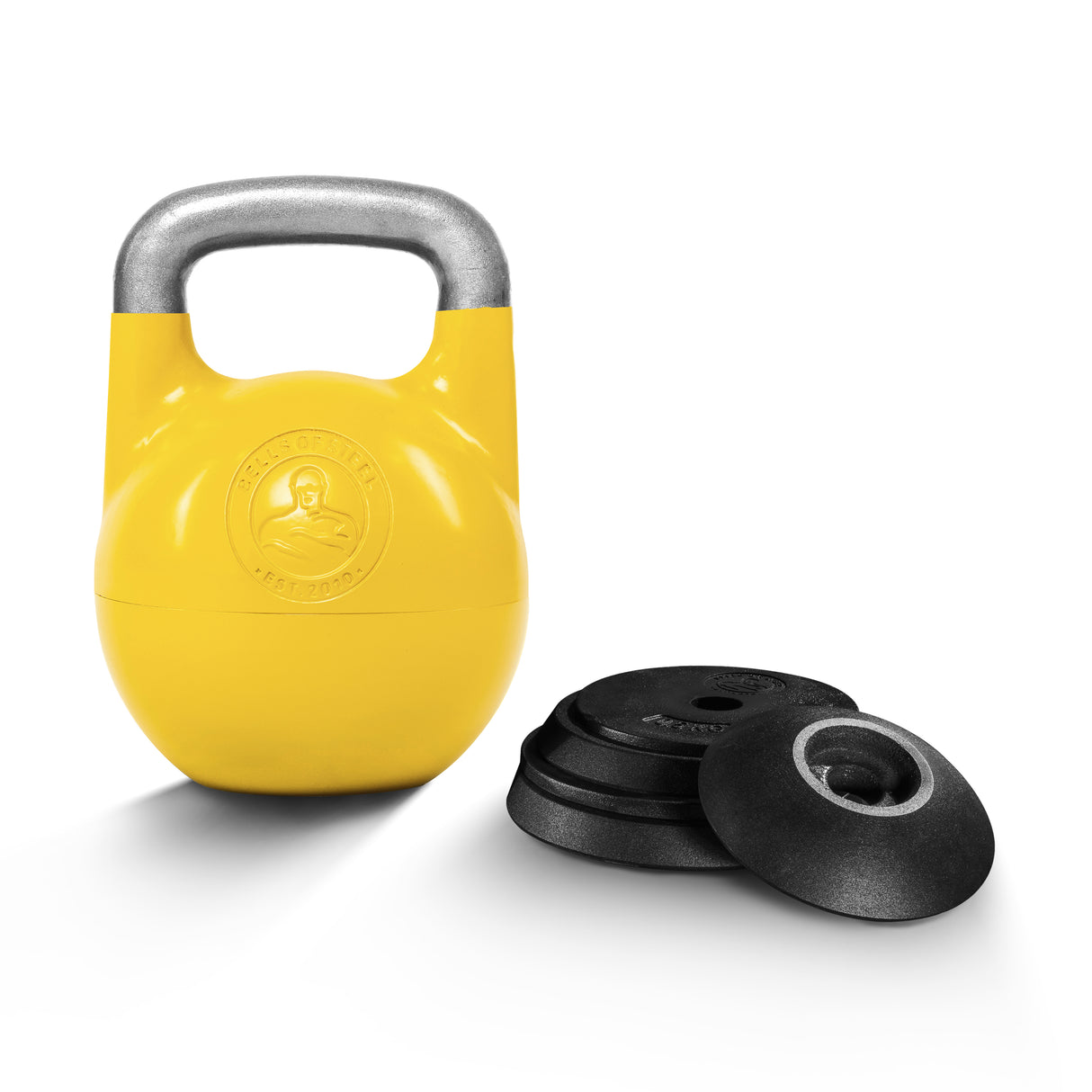 The Bells of Steel Adjustable Competition Kettlebell, featuring a yellow body and silver handle with an embossed logo, is displayed beside black weight plates on a white background.