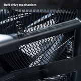 Close-up of the belt drive mechanism on the Bells of Steel Residential Air Bike with Wind Guard, featuring interlocking metal bars and a mesh guard—ideal for home gyms. "Belt drive mechanism" appears in bold white text at the top left.