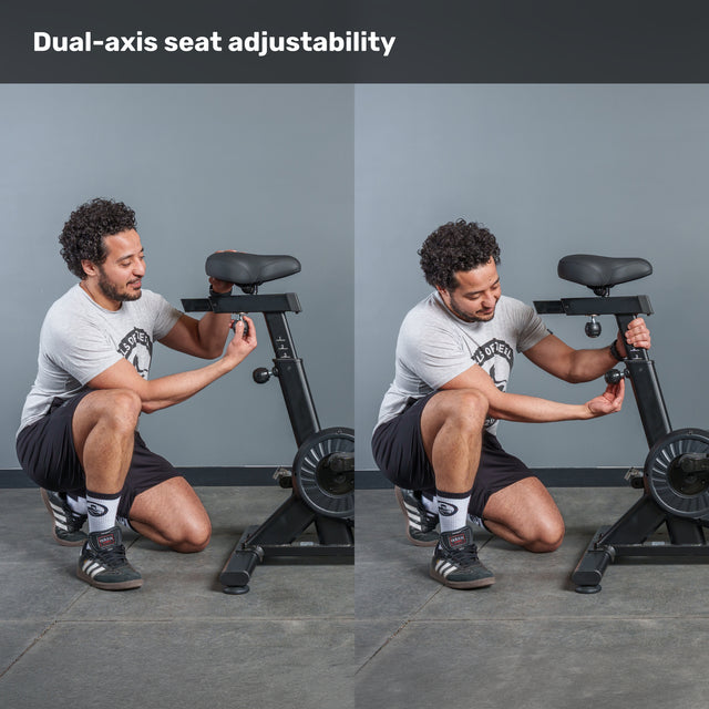 A man demonstrates dual-axis seat adjustability on the Bells of Steel Residential Air Bike with Wind Guard, showing different seat heights and positions. Text above reads: "Dual-axis seat adjustability—perfect for any home gym.